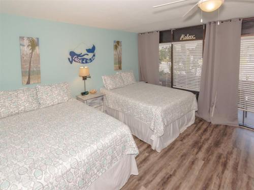 a bedroom with two beds and a window at LR 121 - Gone Coastal in Rockport