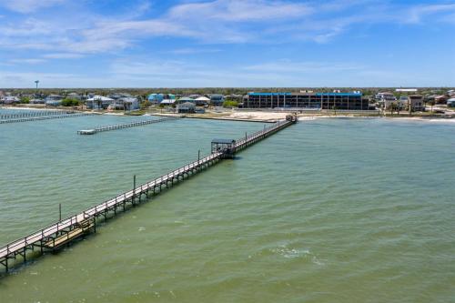a dock in the middle of a body of water at Laguna Reef #121 - Gone Coastal in Rockport
