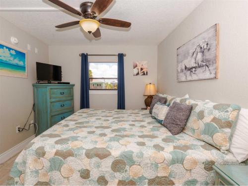 a bedroom with a bed and a ceiling fan at LR 210 - Mustang Isle in Rockport