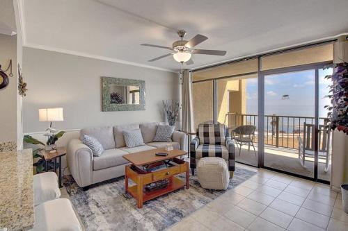 a living room with a couch and a ceiling fan at Laguna Reef #306 - Capm Kens in Rockport