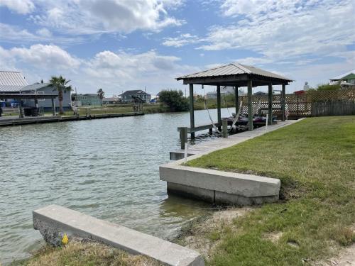 a gazebo next to a body of water at Mermaid Bay in Rockport
