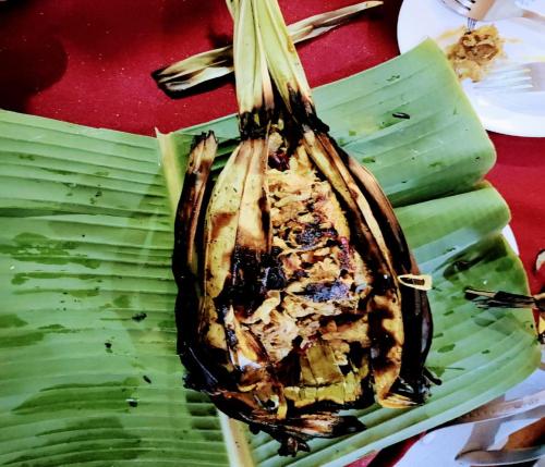 a dead fish on top of a banana leaf at Resort Raktokorobi Karugram - Escape to Green Stay with Soul in Srī Niketan