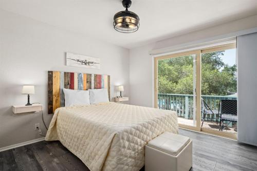 a bedroom with a bed and a large window at Sea La Vie in Rockport