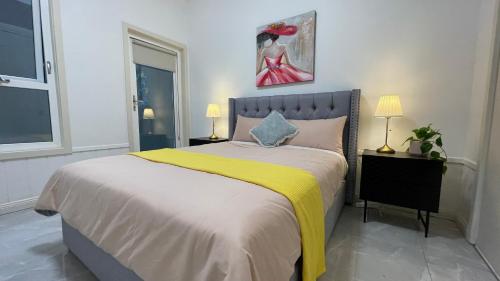 a bedroom with a large bed with a yellow blanket at Spacious Villa Holiday Staycation in Canterbury East of Melbourne in Balwyn