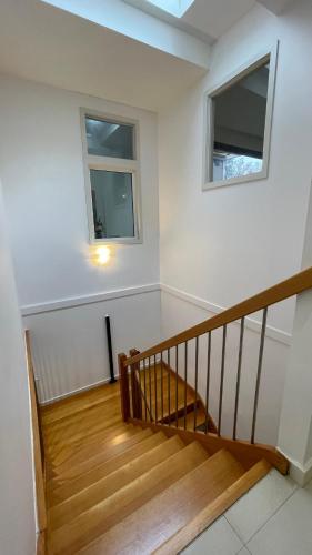 a staircase in a house with two windows at Spacious Villa Holiday Staycation in Canterbury East of Melbourne in Balwyn