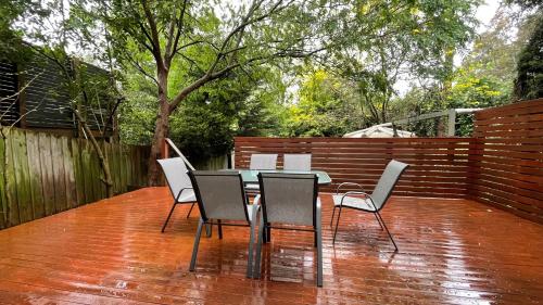 a patio with a table and chairs on a deck at Spacious Villa Holiday Staycation in Canterbury East of Melbourne in Balwyn