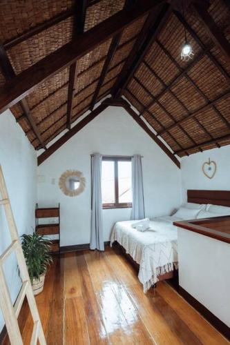 a large room with two beds and a window at BayayTagoSiargao in General Luna