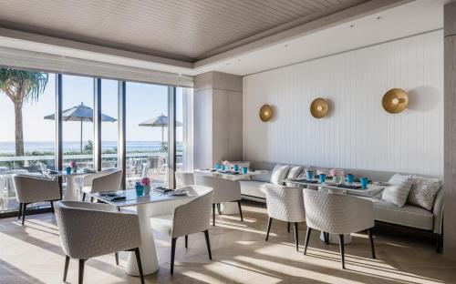a restaurant with tables and chairs with a view of the ocean at The Langham, Gold Coast and Jewel Residences in Gold Coast