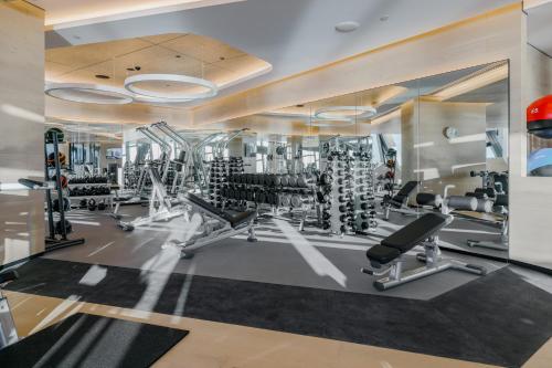 a gym with several treadmills and weights at The Langham, Gold Coast and Jewel Residences in Gold Coast