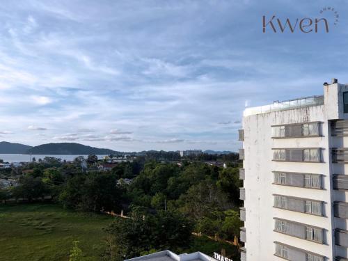 a building with a view of the water and a city at KWEN Suites-Tanjung Aru InfinityPool Seaview/Airport View in Kota Kinabalu