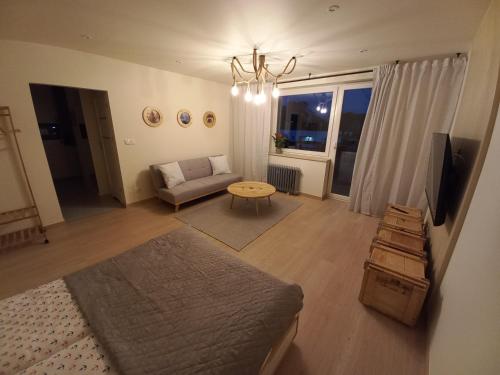 a living room with a couch and a table at Apartament u Szkutnika in Puck