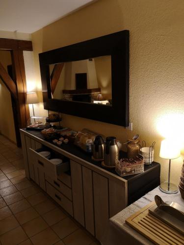 a kitchen with a large mirror on the wall at Domaine de la Borde in Damparis
