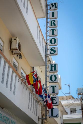 a sign for a hotel on the side of a building at Mirtos Hotel in Myrtos