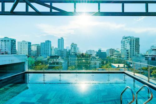 a swimming pool with a view of the city at Dérive Boutique Villa & Apartment Da Nang in Da Nang