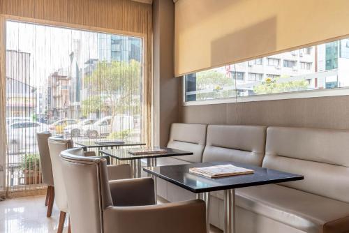 a restaurant with tables and chairs and a window at Residence Hotel By Ketenci in Izmir