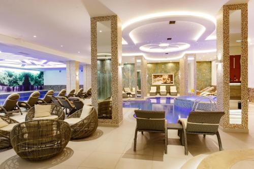 a salon at a hotel with chairs and tables at Hotel Buket Zlatibor in Zlatibor