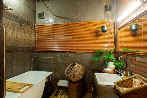 a bathroom with a bath tub and a sink at Bamba Hotel Tokyo-Private Townhouse- in Tokyo