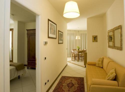 a living room with a couch and a dining room at Residence Montefiore in San Baronto