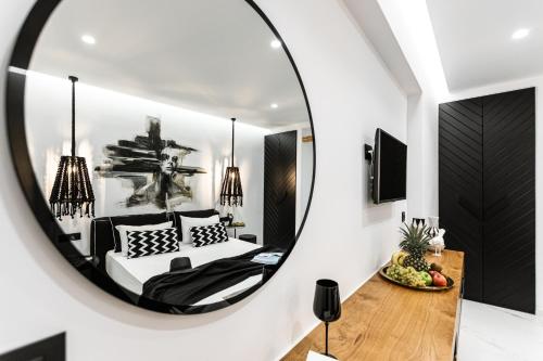 a bedroom with a mirror and a bed at Hotel Palatia in Naxos Chora