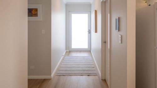 an empty hallway with a door leading into a room at Serenity by the Sea in Busselton