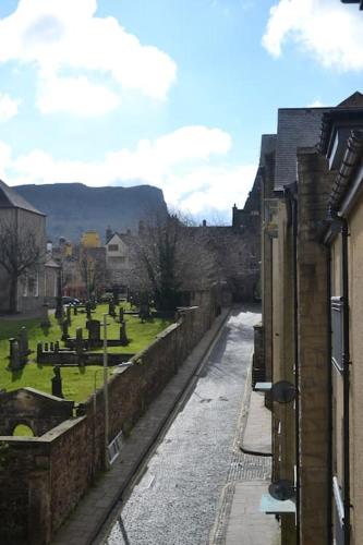 a view of a cemetery next to a building at Next to the Palace and Royal Mile with parking in Edinburgh