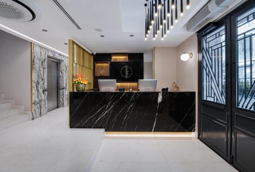 a lobby with a black counter with two laptops on it at Gleam Collection Hotel in Istanbul