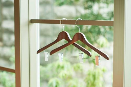 a pair of wooden hangers in front of a window at Sotetsu Grand Fresa Kumamoto in Kumamoto