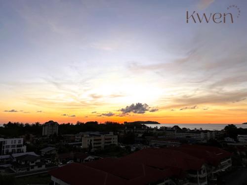 a sunset over a city with buildings and the ocean at KWEN Suites-Tanjung Aru InfinityPool Seaview/Airport View in Kota Kinabalu