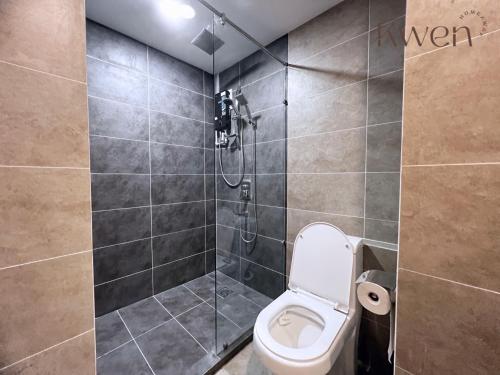 a bathroom with a toilet and a shower at KWEN Suites-Tanjung Aru InfinityPool Seaview/Airport View in Kota Kinabalu
