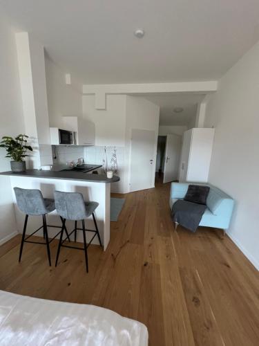 a kitchen and living room with a table and chairs at Pannonia Appartements in Bad Tatzmannsdorf