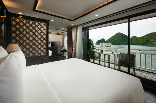 a bedroom with a large bed and a large window at Hermes Cruises in Ha Long
