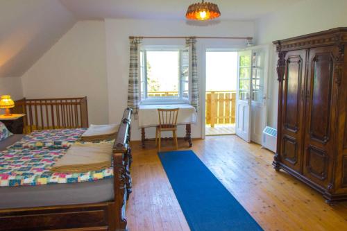 a bedroom with a bed and a table and a window at Drautal Alm Schönbuch in Steinfeld
