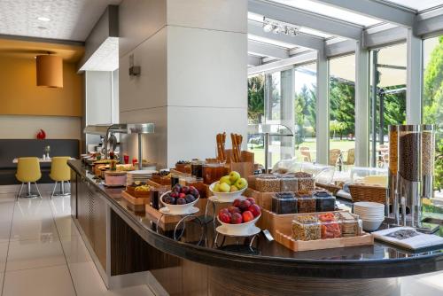 a buffet line with food on it in a restaurant at Ibis Kayseri in Kayseri