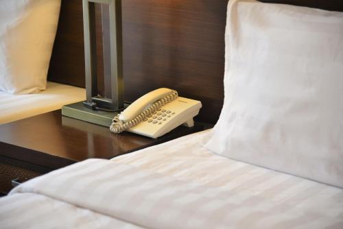 Una cama o camas en una habitación de Afraa Hotel Al Aziziya