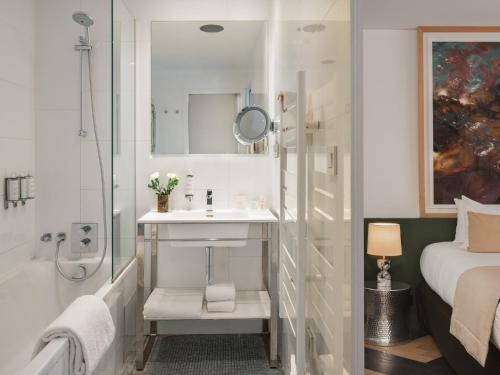 a bathroom with a sink and a shower at Le Rayz Vendome in Paris