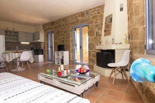 a living room with a bed and a table at Orfea's Place in Riglia