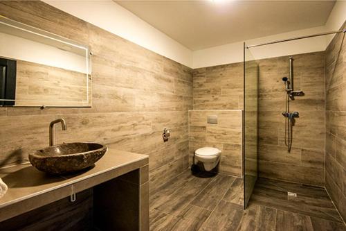 a bathroom with a sink and a shower and a toilet at Via Mare in Sainte-Lucie de Porto-Vecchio