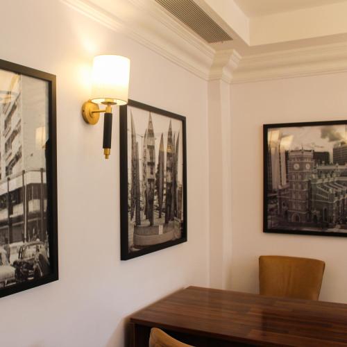 a dining room with a table and pictures on the wall at Victoria Crown Plaza Hotel in Lagos