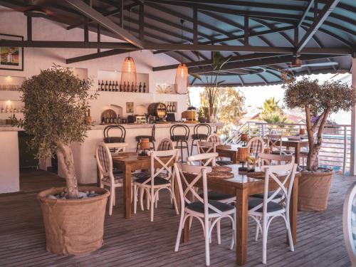 a restaurant with wooden tables and chairs and plants at Monta Verde Hotel & Villas in Oludeniz
