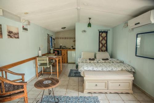 a bedroom with a bed and a table in it at Carmey Avdat Farm in Midreshet Ben Gurion
