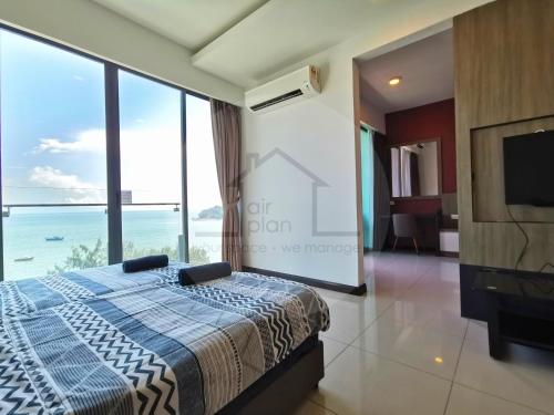 a bedroom with a bed with a view of the ocean at PD D'Wharf Premium Suite - Full Seaview (Up to 6 Pax) in Port Dickson