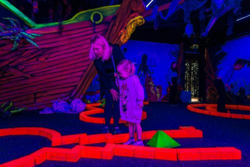a woman standing next to a child in a room at EuroParcs Poort van Zeeland in Hellevoetsluis