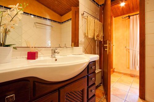 a bathroom with a sink and a mirror at Villa Magdalena in Calvia Town