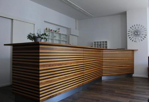 a lobby with a wooden counter top in a room at Gasthaus zum Ritter in Karlsdorf-Neuthard