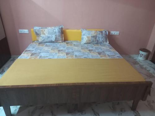 A bed or beds in a room at Axar Complex (1BHK)