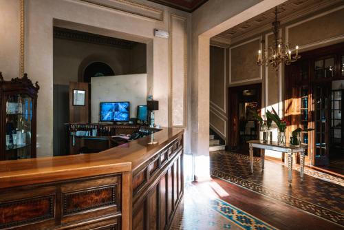 a large room with a wooden counter in a building at Hotel De La Ville in Riccione