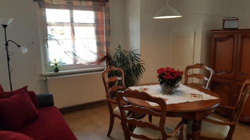 a living room with a table with flowers on it at FEWO Lichtblick in Bautzen