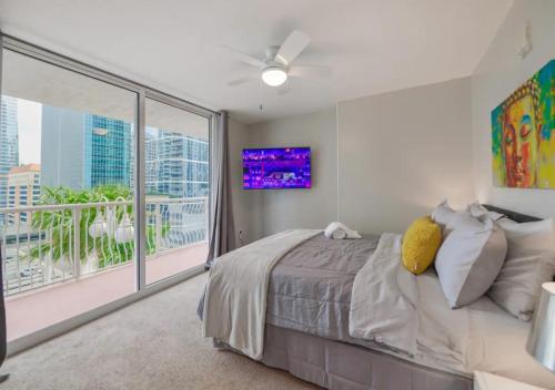 a bedroom with a bed and a large window at Attractive 2/2 Condo In Brickell With Pool in Miami