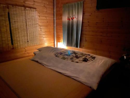 a bed in a room with a window at Takayama Ninja House in Takayama