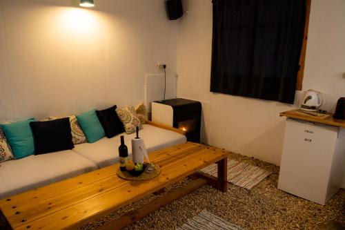a living room with a couch and a wooden table at Carmey Avdat Farm in Midreshet Ben Gurion